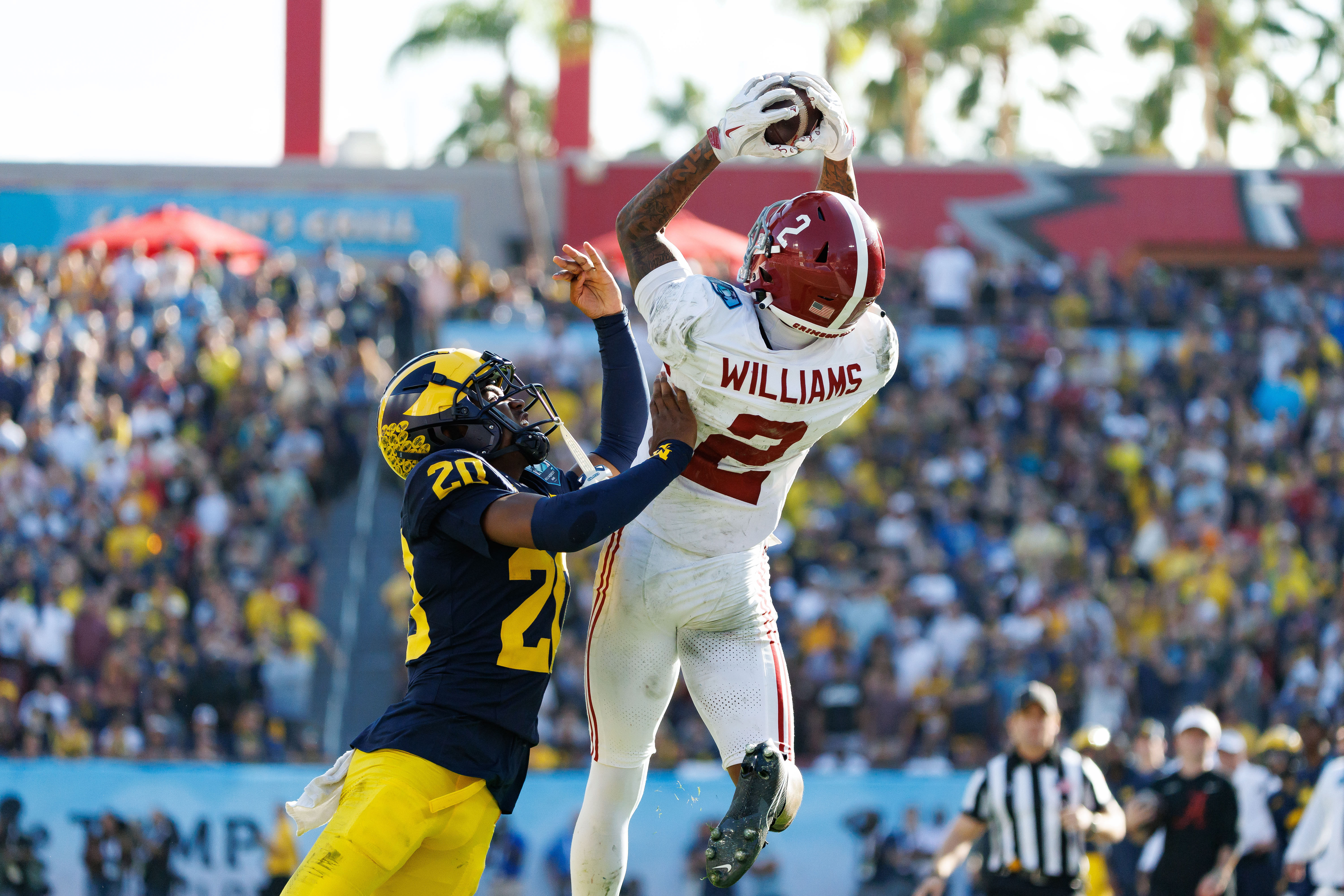 Alabama Crimson Tide wide receiver Ryan Williams (2) makes a catch while Michigan Wolverines defensive back Jyaire Hill (20) pushes him out of bounds. (Credits: IMAGN)